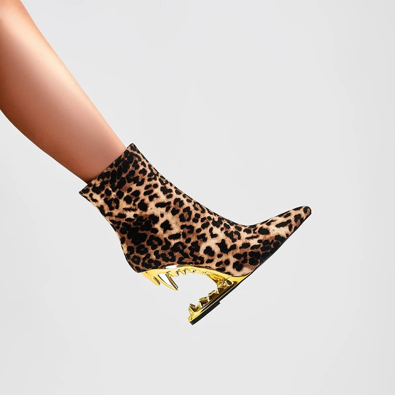Leopard print ankle boot with gold heel on a light gray background