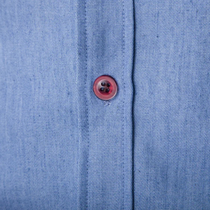 Close-up of a blue fabric shirt with a button