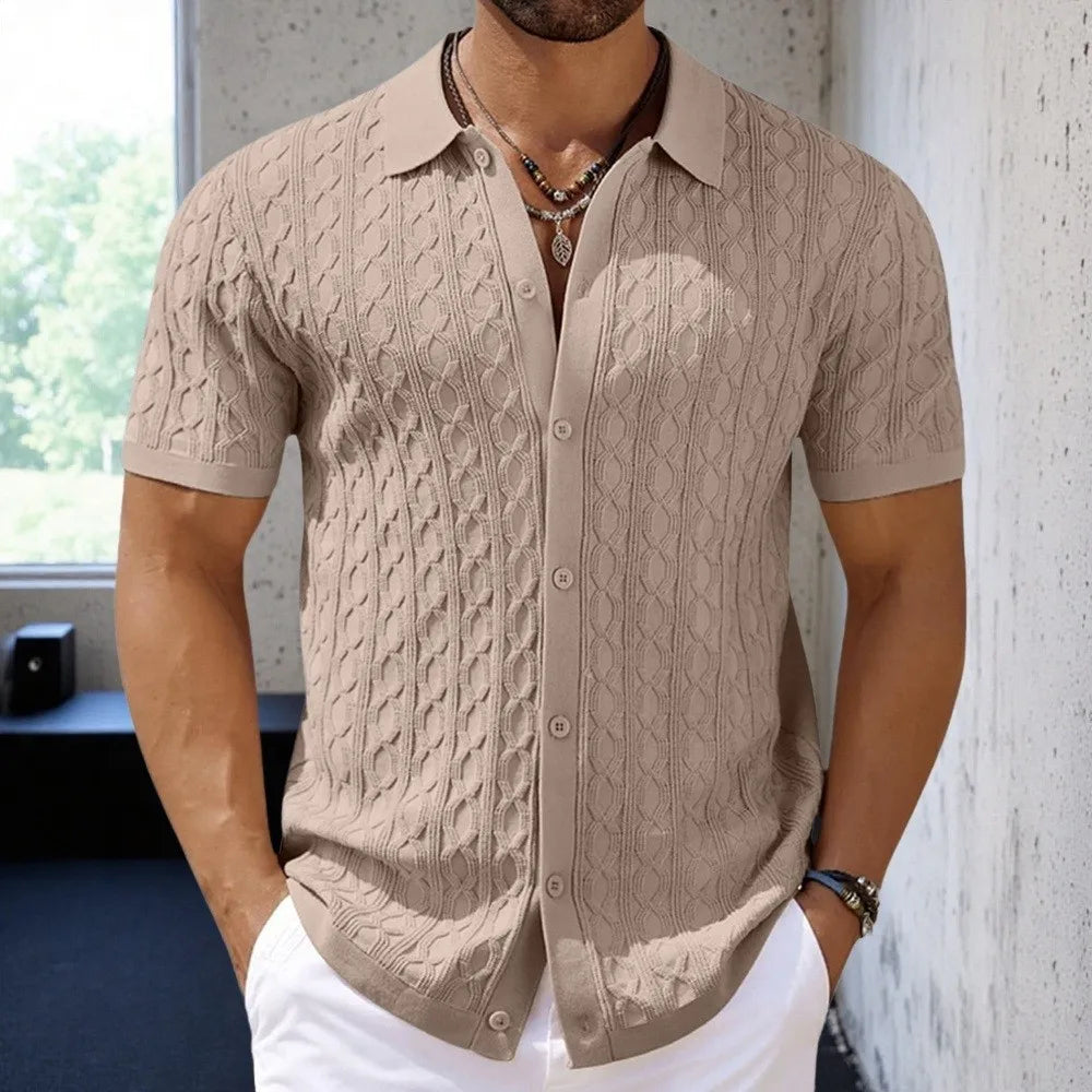Man wearing a beige cable knit short-sleeve shirt with a blurred background