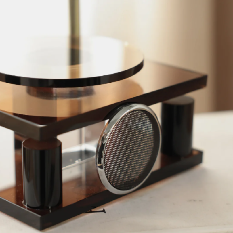 Decorative table with a metallic center piece on a neutral background