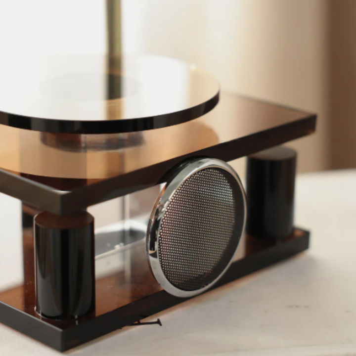 Decorative table with a metallic center piece on a neutral background