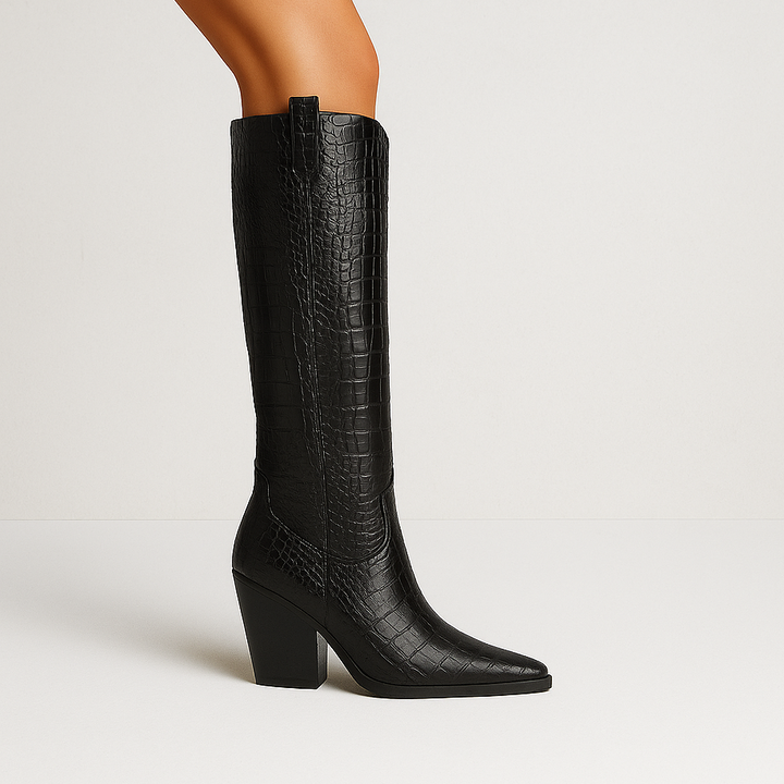 Black knee-high boot with a block heel on a light gray background