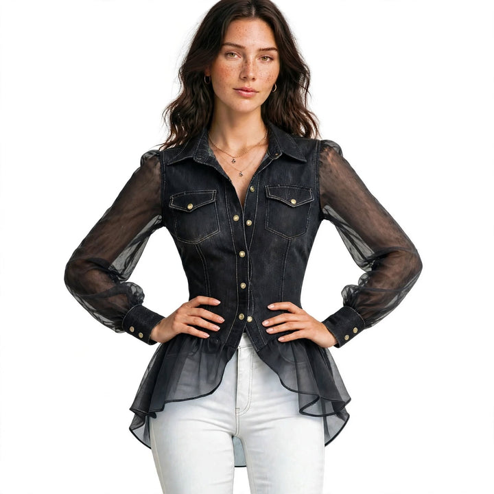 A woman modeling a black sheer mesh long-sleeve button-up shirt with a fitted denim-like torso, white pants, and gold-tone buttons, against a plain white background.