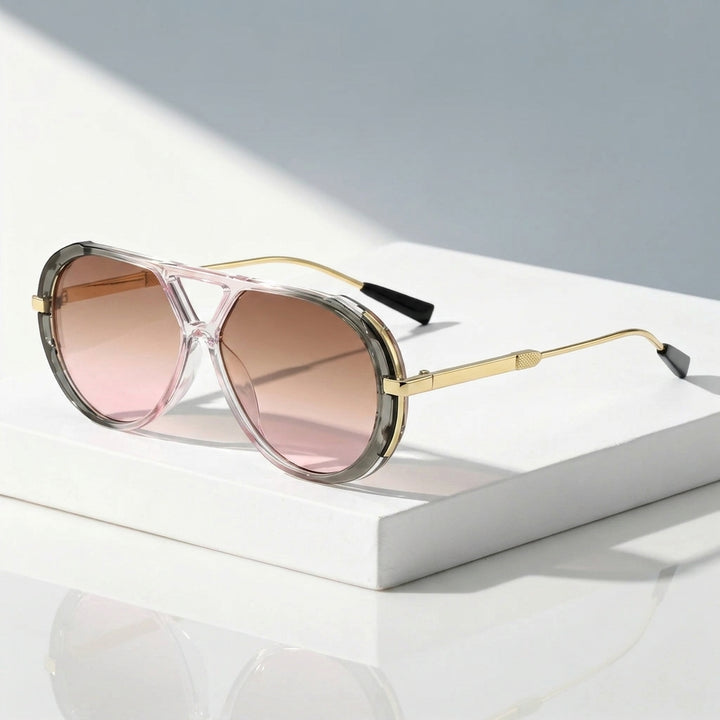 Aviator-style sunglasses with a translucent pink frame, gold metal arms, and pink-tinted lenses, displayed on a white rectangular pedestal.