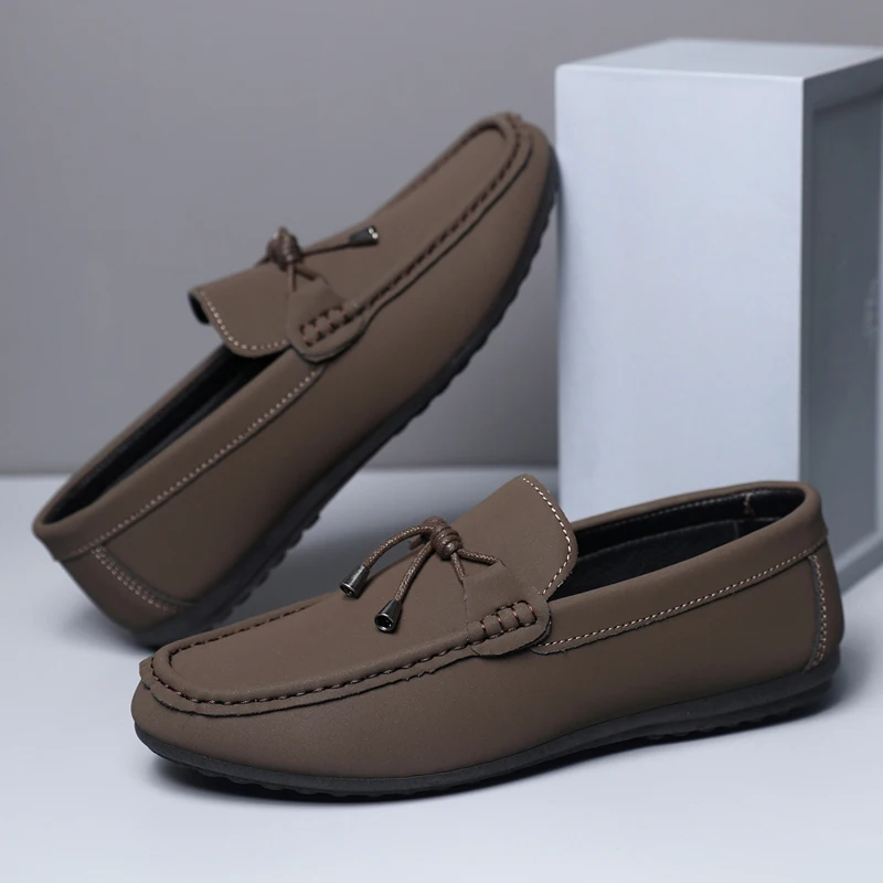 Pair of brown loafers on a light gray background